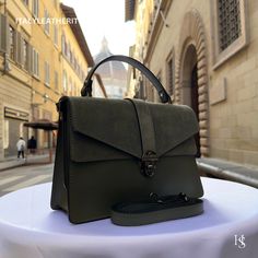 This bag has been made of the best genuine leather by local master crafters of Florence in Italy, designed for women who only accept premium Italian quality and luxury leather bags and modern Italian fashion. . Sizes: Width: 29cm/10.6 inch Height: 19cm/7.4 inch Depth: 7 cm/3.9 inch The story of this bag:  John was visiting Florence with his family and he wanted to find the perfect gift for his wife and daughters. He had heard about the exquisite leather craftsmanship in the city and was determined to find something unique and special. After wandering around the streets for a while, John stumbled upon a small leather shop. As soon as he stepped inside, he was greeted by the warm scent of leather and the sight of beautiful bags lining the shelves. One particular bag caught John's eye - a stu Leather Flap Bag With Smooth Grain For Daily Use, Daily Use Leather Flap Bag With Smooth Grain, Formal Leather Flap Bag With Leather Handles, Luxury Leather Flap Bag For Daily Use, Workwear Flap Bag With Textured Leather, Olive Leather Shoulder Bag With Detachable Strap, Textured Leather Flap Bag For Daily Use, Leather Flap Bag With Leather Lining For Daily Use, Leather Flap Bag With Leather Lining For Work