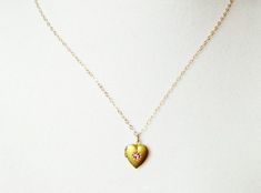 So cute and dainty !Tiny heart locket has a cute pink centerInside there is room for a small pictureChoose chain length at checkout Dainty Open Heart Locket Necklace, Dainty Open Heart Locket Necklace With Heart Charm, Dainty Heart Locket Charm Necklace, Dainty Heart Pendant Locket Necklace With Charm, Dainty Heart Locket Necklace With Charm, Vintage Pink Necklaces For Valentine's Day, Dainty Rose Gold Heart Locket Necklace, Vintage Pink Necklace For Valentine's Day, Pink Heart Charm Necklace With Heart Pendant