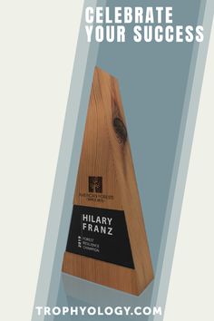 a wooden trophy with the words, celebrate your success