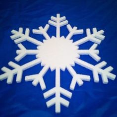 a snowflake made out of foam on a blue background