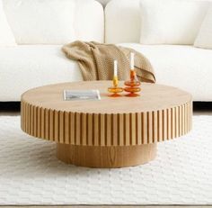 a living room with a white couch and wooden table