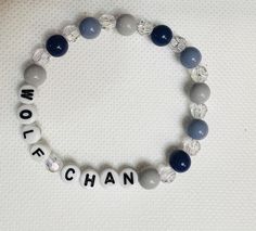 Wolfchan Skzoo themed bracelet with blue and gray beads Casual Customized Blue Beaded Bracelets, Casual Blue Customizable Beaded Bracelets, Casual Blue Name Bracelet With Round Beads, Casual Blue Beaded Name Bracelet, Casual Gray Beaded Bracelets As Gift, Casual Gray Beaded Bracelets, Customizable Casual Blue Jewelry, Handmade Casual Gray Bracelets, Gray Adjustable Stretch Bracelet As Gift