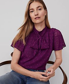 Elevate your wardrobe with the Ann Taylor Mock Neck Bow Top, a blend of elegance and comfort. This top features a sophisticated mock neck with charming bow ties and delicate shirring details below, creating a beautifully feminine silhouette.

- Size: XS (Regular)
- Color: Pulsar Purple
- Material: 100% Polyester
- Gender: Female
- Sleeve Length: Short
- Body Lining: Yes
- Length: 23 1/2 inches long
- Care Instructions: Machine Washable

Perfect for both office and casual wear, this blouse is des Pussycat Bow Blouse, Mock Neck Short Sleeve, Female Sleeve, Bow Top, Neck Bow, Blazer And Skirt, Bow Blouse, Feminine Silhouette, Blouse Tops