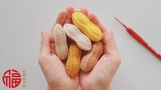 a person holding out their hand made corn cobs