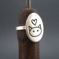 This is so simple and so cute! I hand make this ring in my Oakland studio. The top of the ring measures 3/4 of an inch tall and the entire ring is solid sterling silver. If the whole sizes in the drop down menu don't match your size send us your ring size in notes to seller at checkout. All rings are made to order and take about a week before we send them out. To see the matching necklace go here: https://www.etsy.com/listing/198777553/love-me-love-my-cat-necklace-sterling?ref=shop_home_active_7 Handmade Cute Sterling Silver Rings, Cute Handmade Sterling Silver Rings, Adjustable Sterling Silver Cat Design Rings, Silver Cat Ring, Sterling Silver Cat, Cat Ring, Silver Cat, Cat Necklace, Matching Necklaces