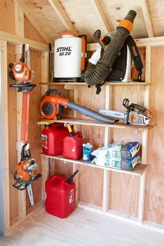 there are many tools on the shelves in this shed, including chainsaws and other items