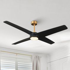 a black ceiling fan in a white room