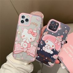 two hello kitty phone cases sitting next to each other