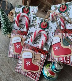 three christmas gift bags with candy canes on them