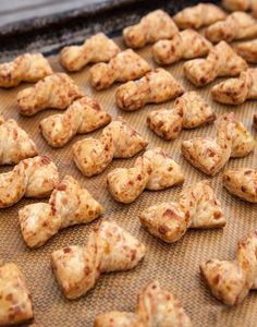 there are many pieces of food on the baking trays ready to be baked in the oven