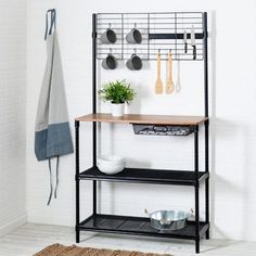 a shelf with pots, pans and utensils hanging from it's sides