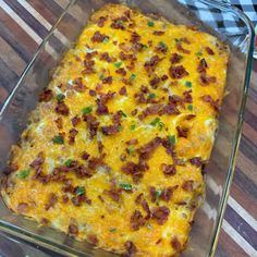 a cheesy casserole with bacon and cheese in a glass baking dish