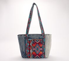 Bold and bright colored embroidery pairs with denim on the stylish Nevoso tote. With twin handles and plenty of room for storage, this bag is ready to accompany you on your travels or suit your day-to-day needs. From Patricia Nash. Embroidered Denim Bags For Everyday Use, Casual Travel Bags With Multicolor Embroidery, Casual Multicolor Embroidered Travel Bags, Casual Embroidered Denim Bag, Casual Multicolor Embroidery Travel Bags, Blue Embroidered Canvas Bags, Casual Shoulder Bag With Multicolor Embroidery For Everyday Use, Casual Multicolor Embroidered Shoulder Bag For Everyday Use, Casual Tote Shoulder Bag With Multicolor Embroidery