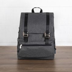 a gray backpack sitting on top of a wooden floor