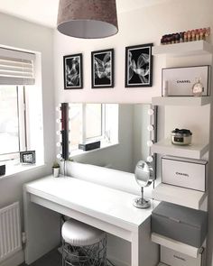 a white desk with drawers and a mirror above it