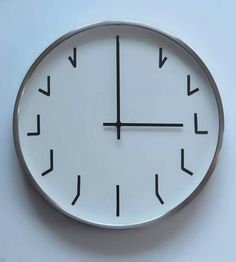 a white clock with black numbers and arrows on it's face against a blue background