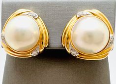 Beautiful Vintage 14K Yellow Gold Diamond 0.25ct Fresh Water Pearl Earrings  A perfect gift for your loved one!  Total Earring Weight: 11.37g  Total Diamond: 0.25ct Earring Length: 20.01mm Earring Width: 19.71mm Earring Closure: Clip on Earrings  Item will be placed in a gift box. * Luxury 22k Gold Traditional Pearl Earrings, Classic White Gold Clip-on Earrings For Anniversary, Classic Brilliant Cut Clip-on Earrings For Formal Occasions, Classic Brilliant Cut Clip-on Earrings For Formal Events, Classic Formal Clip-on Earrings With Brilliant Cut, Elegant Yellow Gold Clip-on Diamond Earrings, Classic Formal Brilliant Cut Clip-on Earrings, Yellow Gold Clip-on Diamond Earrings For Anniversary, Anniversary Yellow Gold Clip-on Diamond Earrings