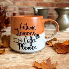 an orange and white coffee mug with the words autumn leaves and coffee please on it