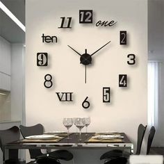 a clock that is on the wall above a dining room table with chairs and place settings