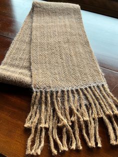 Handwoven alpaca scarf all natural colors in herringbone type pattern. end is hemstitched with fringe. Handwoven Alpaca Winter Scarf, Handwoven Alpaca Scarves For Winter, Handwoven Alpaca Scarves For Fall, Fall Handwoven Alpaca Scarf, Fall Alpaca Handwoven Scarves, Handwoven Brown Scarves For Fall, Brown Handwoven Winter Scarves, Herringbone Scarf, Alpaca Scarf