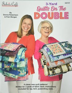 two women standing next to each other holding quilts on the cover of a magazine