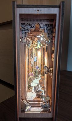 an intricate wooden clock with butterflies on it