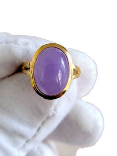 "'The Qīng Purple Jade Ring' represents Royalty. The Chinese character for Qing is composed of 'water' (氵) and 'azure' (青) which are associated to the water element in Chinese philosophy.  The water imagery and clean silhouette of the Ring makes a striking impression and enhances the beauty of the jadeite stone in the center. Crafted in 14K gold, the Qīng Purple Jade Ring is handset with a handpicked Purple Jade gemstone. Ring Sizes Available. Matching Qīng Purple Jade earrings and pendants are Timeless Polished Amethyst Ring For Gift, Timeless Amethyst Ring With Polished Finish, Timeless Amethyst Ring With Polished Finish As Gift, Yellow Gold Cabochon Amethyst Ring Gift, Elegant Untreated Gemstones For Anniversary, Chinese Philosophy, Resin Jewelry Diy, Purple Jade, Jade Gemstone