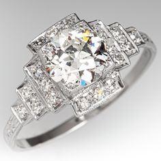 This gorgeous ring is centered with a round transitional brilliant cut diamond, weighing 1.54 carats, in a square bead setting. The top of the ring is accented with engraving and milgrain details and is bead set with a total of eighteen (18) round single cut diamonds. The ring measures 11.8mm at the top, rises 5.4mm above the finger, tapering to 1.8mm wide and 0.8mm thick at the base of the shank. This ring is currently a size 11.25. Luxury Platinum Diamond Ring For Formal Occasions, Luxury White Gold Heirloom Wedding And Engagement Rings, Luxury Vintage White Gold Rings, Luxury Antique Wedding And Engagement In Diamond White, Luxury White Diamond Platinum Ring, Engagement Rings Vintage 1stdibs, Classy Engagement Ring 1stdibs, Luxury Vintage Platinum Wedding And Engagement Jewelry, Luxury Platinum Wedding Ring With Diamond Accents