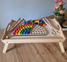 a wooden tray with various colored candies on it