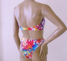 "Bandeau 2-piece bikini has hook-back strapless bandeau top: lined with standard beige swimwear lining; no pads, wires, or foam cups, with boning in sides for support. Eighties high leg Brazilian bikini bottom has minimal back coverage; lined. Nylon/spandex. Mix-and-Match Sizes! Tops available in S-M-L-XL Bottoms: S-M-L-XL. Choose your sizes for each piece from the drop-down lists. SIZING RUNS SMALL, so please read the size chart before ordering: USA SIZE CHART SMALL: Height: 5'0\"-5'4\"; Weight Fitted Tube Top With Adjustable Straps For Poolside, Fitted Underwire Tube Top For Pool, Fitted Multicolor Tube Top For Beach Season, Multicolor Bandeau Tube Top For Poolside, Fitted Triangle Tube Top For Sunbathing, Fitted Tube Top With Adjustable Straps For Pool, Fitted Tube Top For Swimming, Beach Season, Underwire Tube Top For Summer Pool Days, Summer Tube Top With Adjustable Straps For Swimming