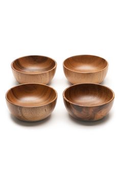 four wooden bowls sitting on top of each other