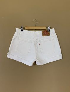 "High waisted 90's denim shorts. Made by Levi's Jeans in classic white denim wash. Shorts are in excellent clean condition. Perfectly worn in with light naturally distressed character. These have been cut off and washed once. Measurements are taken zipped or buttoned up and laid comfortably flat then x 2 for total circumference (inches) Tag Size 12 100% Cotton ~ Measurements taken 'un' rolled Waist 34\" Hips 45.5\" Length 15\" Inseam 4\" Rise 11\" leg opening circumference 26.5\" All items are f 90s High Waist Relaxed Fit Jean Shorts, Vintage Jean Shorts With Belt Loops For Summer, White 90s Style Shorts For Summer, White 90s Style Summer Shorts, 90s High Waist Relaxed Fit Shorts, 90s Style Shorts With Belt Loops, White Cotton Jean Shorts With Belt Loops, 90s Relaxed Fit Cutoff Jean Shorts, 90s Style Cutoff Jean Shorts