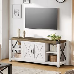 a flat screen tv mounted to the side of a white entertainment center in a living room