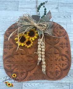 a brown mat with sunflowers and beads on it