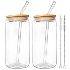 two mason jars with wooden lids and straws