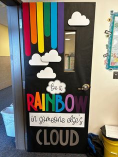 a classroom door decorated with rainbows and clouds