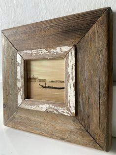 an old wooden frame with a boat in the water