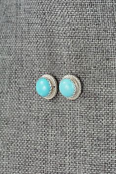 These Campitos turquoise and sterling silver earrings were made by Navajo silversmith Sally Arviso.Length: 7/16" (11mm)Width: 7/16" (11mm)Free shipping on all orders! We ship with USPS and always include tracking. All orders ship within a day of payment.Returns are accepted up to 30 days after you receive your order. Just send us a message. Our shop offers cash back or store credit. The item must be returned in new condition. Sterling Silver Turquoise Cabochon Earrings, Bear Carving, White Buffalo, Pearl Chain, Native American Jewelry, Turquoise Sterling Silver, Free Jewelry, White Vintage, Sterling Silver Earrings