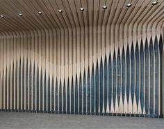 an empty room with wooden slats on the wall and blue tiles on the floor