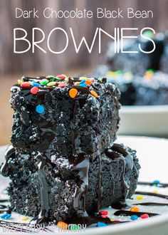 two chocolate brownies stacked on top of each other with sprinkles and chocolate