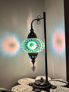 a table with a lamp and doily on it