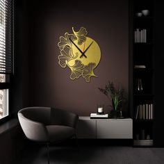 a clock that is on the wall next to a chair in a room with dark walls