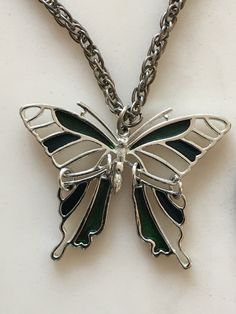 This beautiful antique butterfly pendant necklace is in excellent condition. This piece of jewelry would be a great addition to anyone's collection or as a gift. Elegant Silver Metal Butterfly Necklace, Green Butterfly Charm Pendant Necklace, Metal Butterfly Clavicle Chain Jewelry, Silver Butterfly Necklace With Clavicle Chain, Butterfly Shaped Clavicle Chain Jewelry, Vintage Silver Stainless Steel Necklaces, Vintage Silver Stainless Steel Necklace, Butterfly Shaped Stainless Steel Necklace For Gift, Metal Butterfly Pendant Necklace With Clavicle Chain