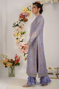 Divine into regal perfection with regal lilac blue. This lilac blue marvel boasts a neckline adorned with vibrant resham, beads and sparkle of sitara, delicately enhanced with beautifully curated bunch on neck line, sleeves and back as well, floral motifs on all over shirt front and intricate resham embroidey and lace work on shirts hem.to complete this ethereal ensemble it is paired with ombre dyed dupatta and two tier ruffled trouser. Shirt Fabric: Pure jacquard maysuri Shirt Length: 48” Pant Blue Marvel, Lilac Blue, Eid Outfits, Wedding Types, Over Shirt, Pakistani Designers, Silk Dupatta, Fashion Consultant, Chiffon Shirt