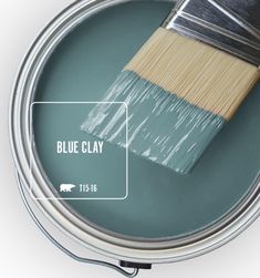 a can of wine leaf paint with a brush