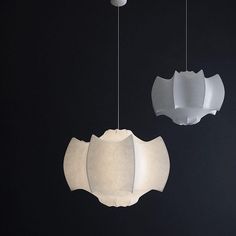 three lamps hanging from the ceiling in a dark room