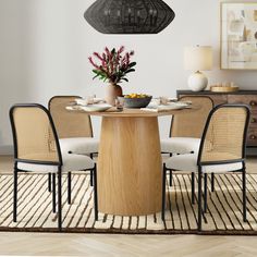 a dining room table with four chairs around it