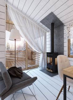 a living room with a couch, chair and wood burning stove in the middle of it