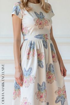 Olivia Mark - Elegant Blooms Midi Dress - Pastel Floral Print Fitted Cotton Dress For Garden Party, Beige Fitted Waist Dress For Spring, Cotton Fitted Midi Dress For Garden Party, Fitted Cotton Midi Dress For Garden Party, Fitted Cream Cotton Dress, Fitted Cotton Cream Dress, Cotton Floral Print Fit And Flare Dress, Beige Printed Fitted Dress, Beige Fitted Printed Dress