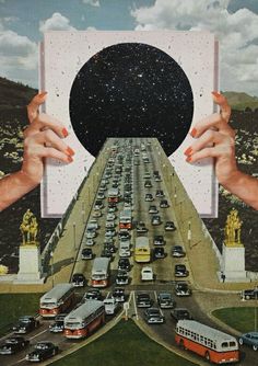 two hands holding up an image of a highway with cars and buses in the middle